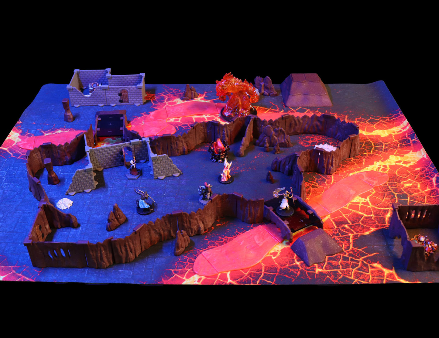 Wide view of the fully assembled modular layout of the Dragon's Lair Adventure Set, configured as a twisting cavern network with large rooms and a lava river running through the terrain.