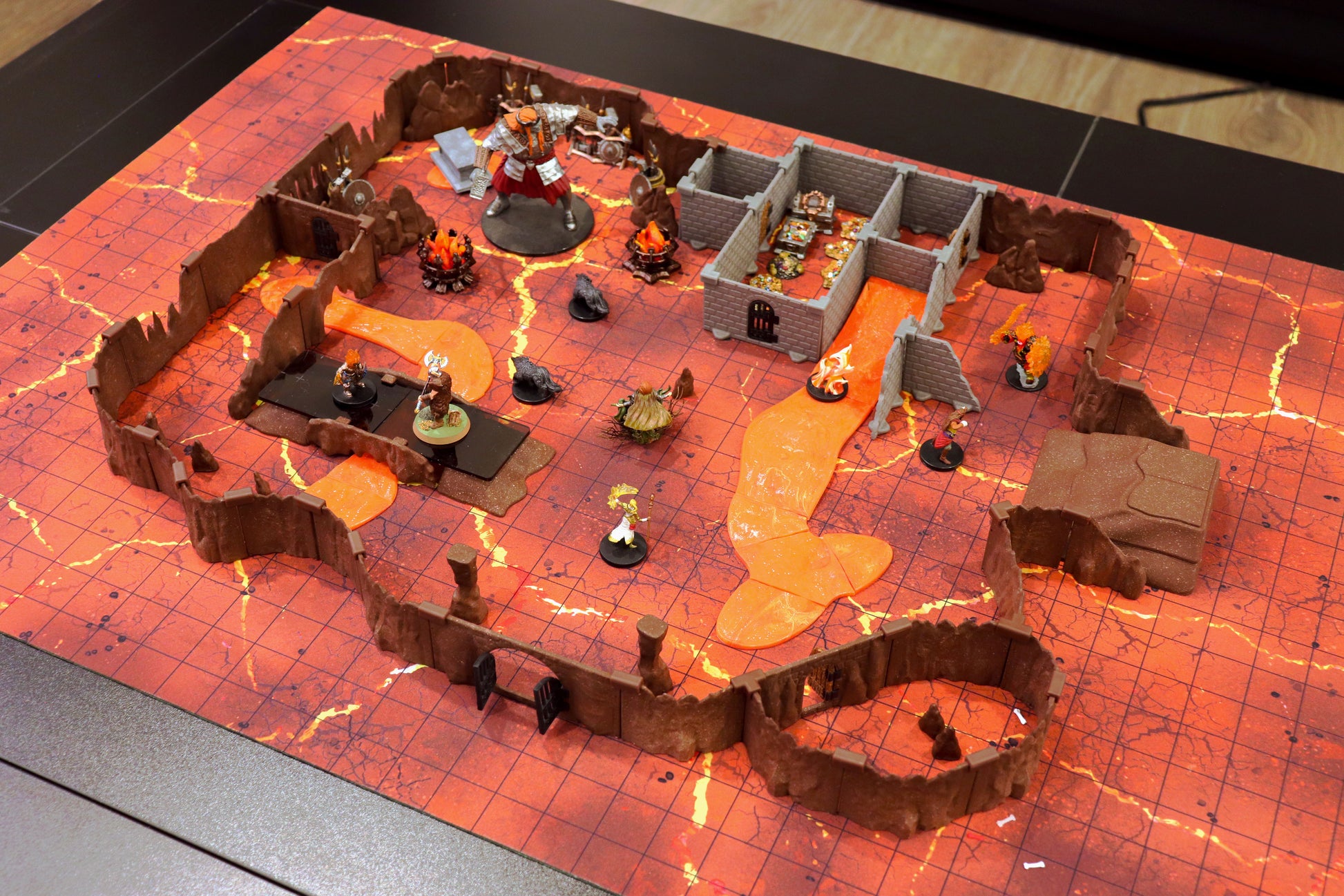 High-angle shot of the Dragon's Lair Set demonstrating its verticality and the use of the terrain to create perilous chasms and elevated positions over the glowing magma pools.