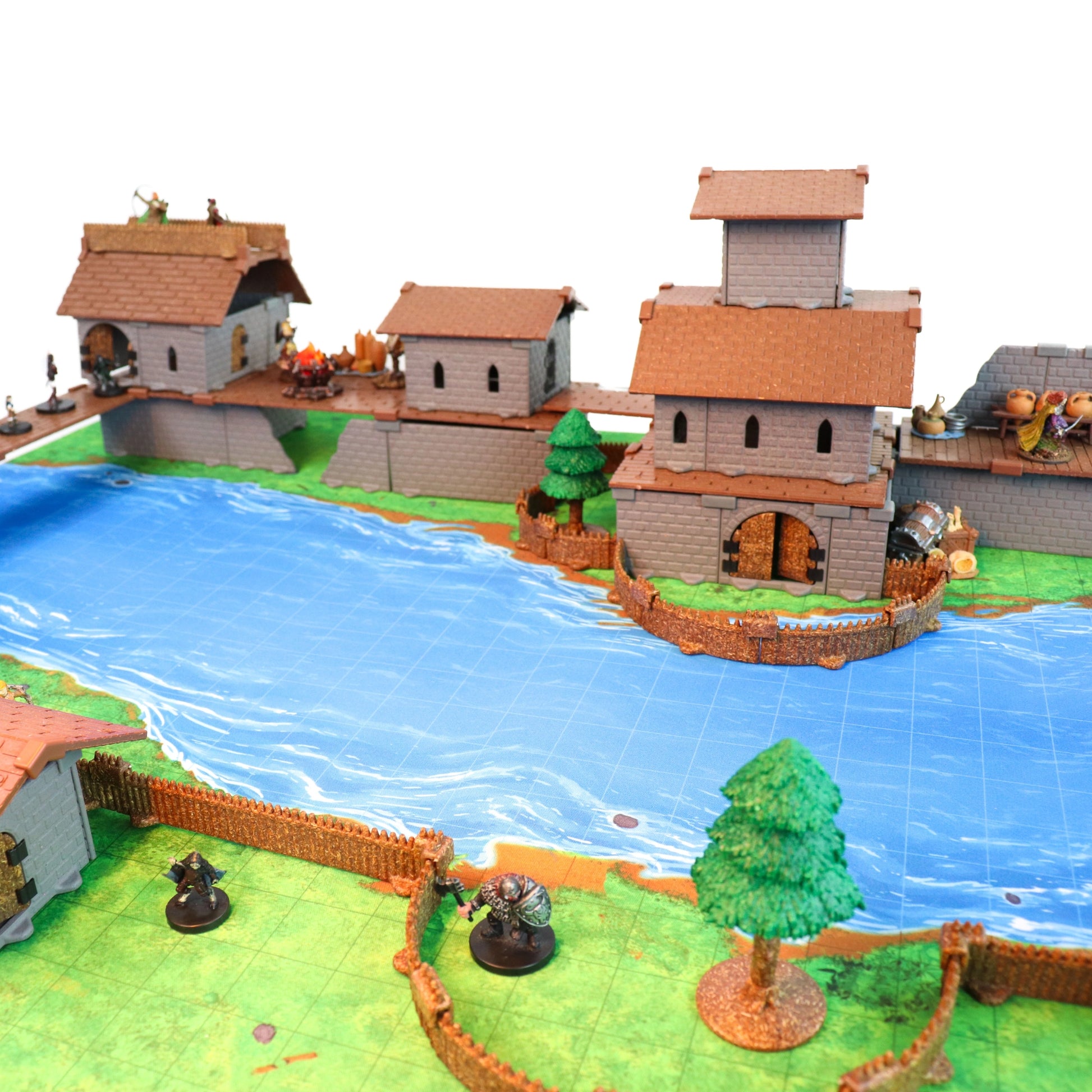 Wide-angle shot of the Village of the Lost Bundle fully assembled as a fortified town with multiple multi-story structures, featuring the new Village Roofs and a perimeter of Palisade Fencing.