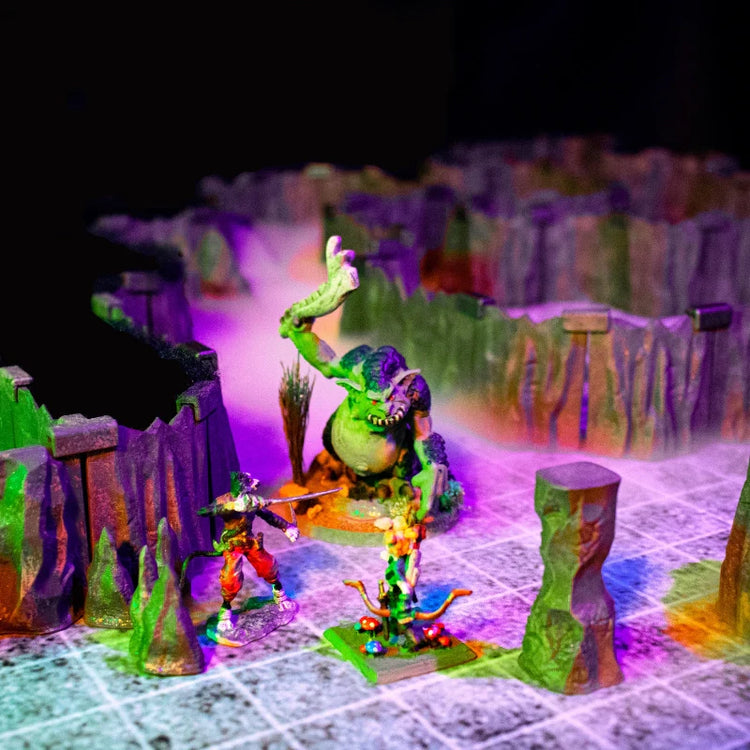A scene of a dark Cavern Set in which several adventurers battle a large troll shrouded in mist.