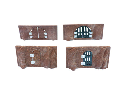 Two modular cavern walls showing installed dark iron door inserts, featuring grated and barred jail door styles.