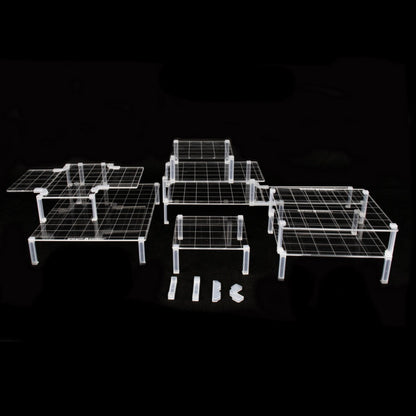 Clear acrylic platforms and clips arranged in a multi-level dungeon terrain setup on a solid black background for visibility.