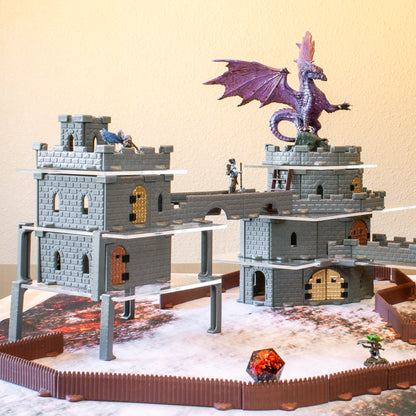 Large, multi-level fantasy castle terrain built using metallic door inserts, featuring a dragon miniature and a D20 die.