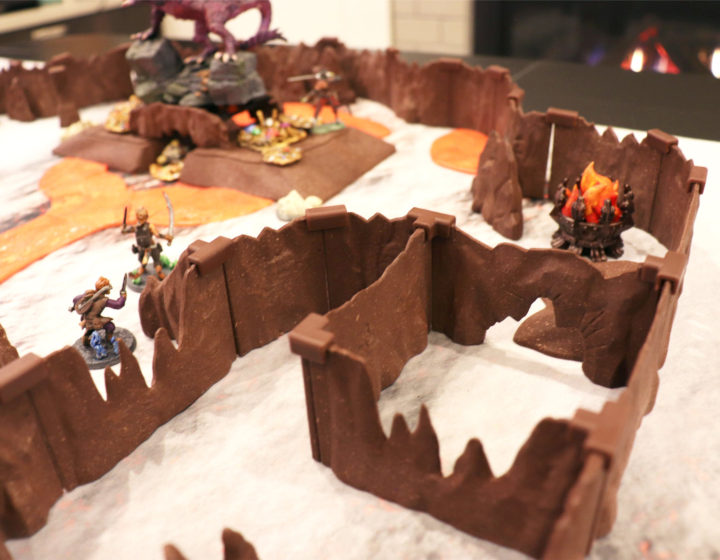 A large setup utilizing the modular Special Cavern Walls to create winding passages, featuring two archer miniatures and a miniature fire pit.