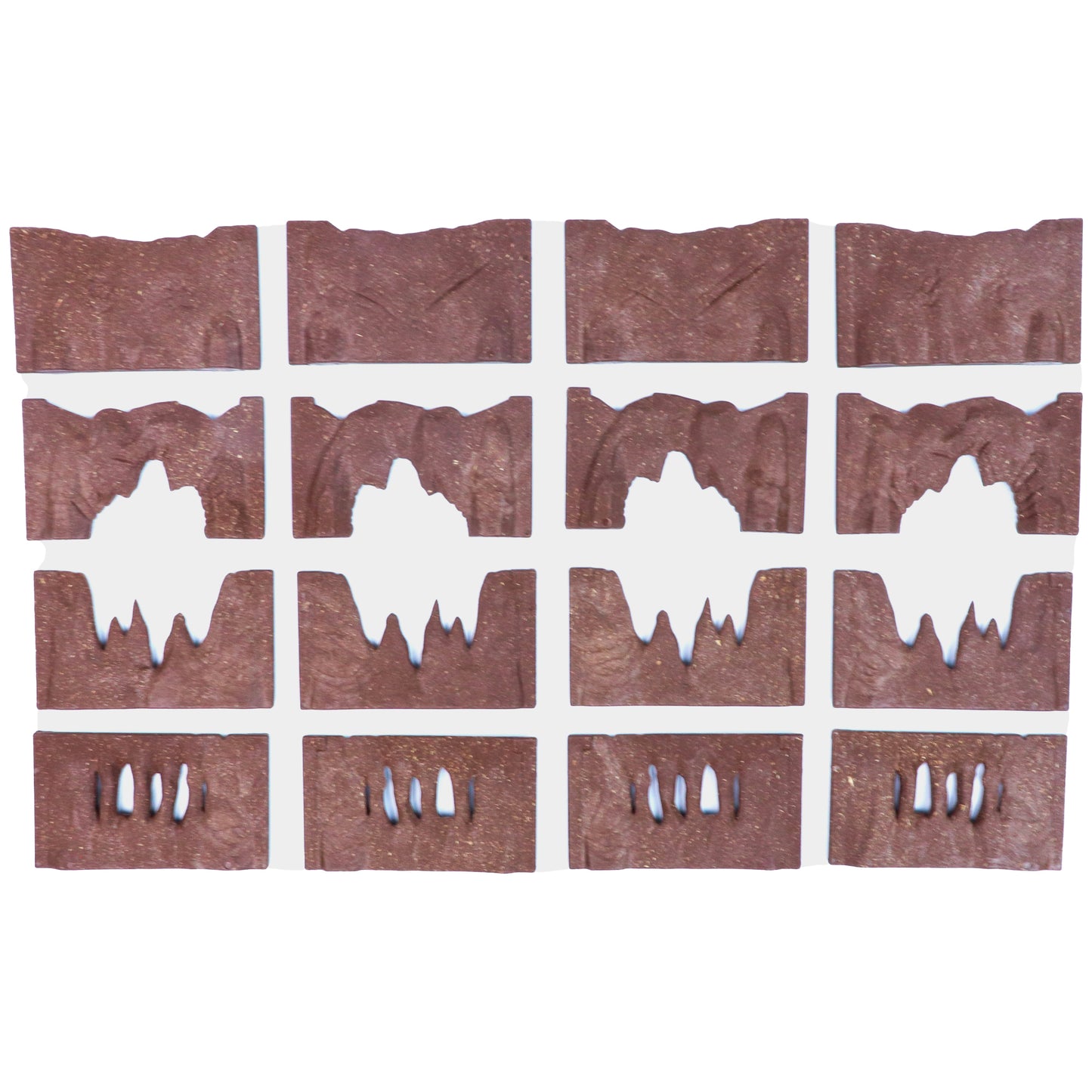 Overhead view of the 16 modular brown cavern wall pieces laid out in four rows of four, showing the various archway and window designs.