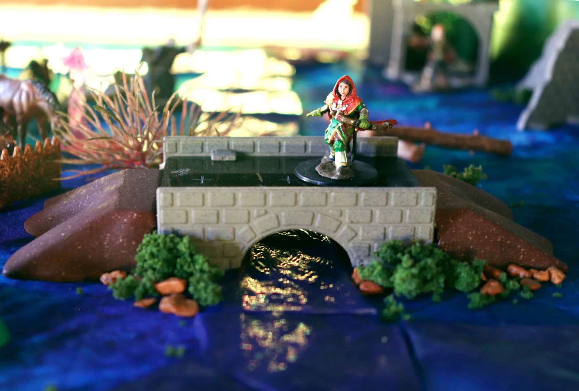 Dirt Ramps used to form the natural banks for a stone bridge, creating a realistic river crossing for tabletop Dungeons and Dragons.