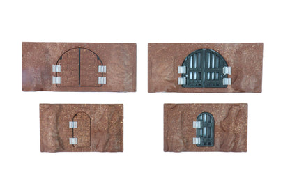 Close-up view of four modular cavern wall sections featuring installed secret brick doors and black iron jail doors.