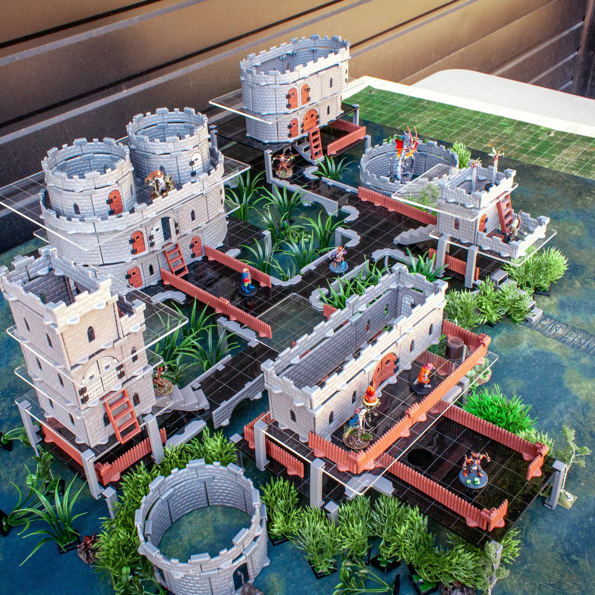 Expansive TTRPG castle terrain built atop the Acrylic Platform Clip system, demonstrating multi-level, walkable elevation.