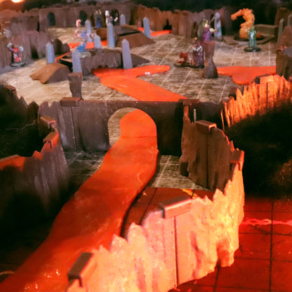 TTRPG dungeon scene featuring a glowing red Lava River flowing under a wall and bridge, bordered by Special Cavern Walls terrain pieces.