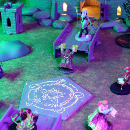 TTRPG battle scene showing a miniature wizard casting a spell over a glowing Summoning Circle platform with other heroes and castle terrain in the background.