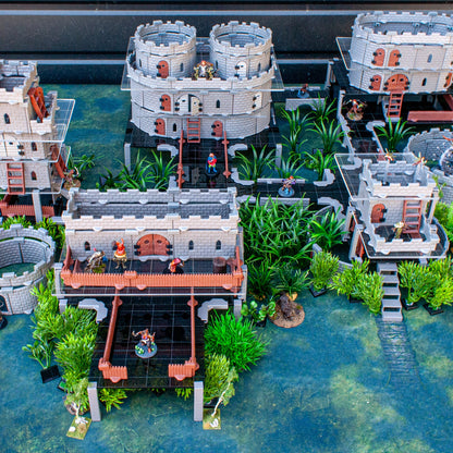 Close-up of a complex DND castle structure supported by the acrylic platform clips, integrated with scatter terrain and miniatures.