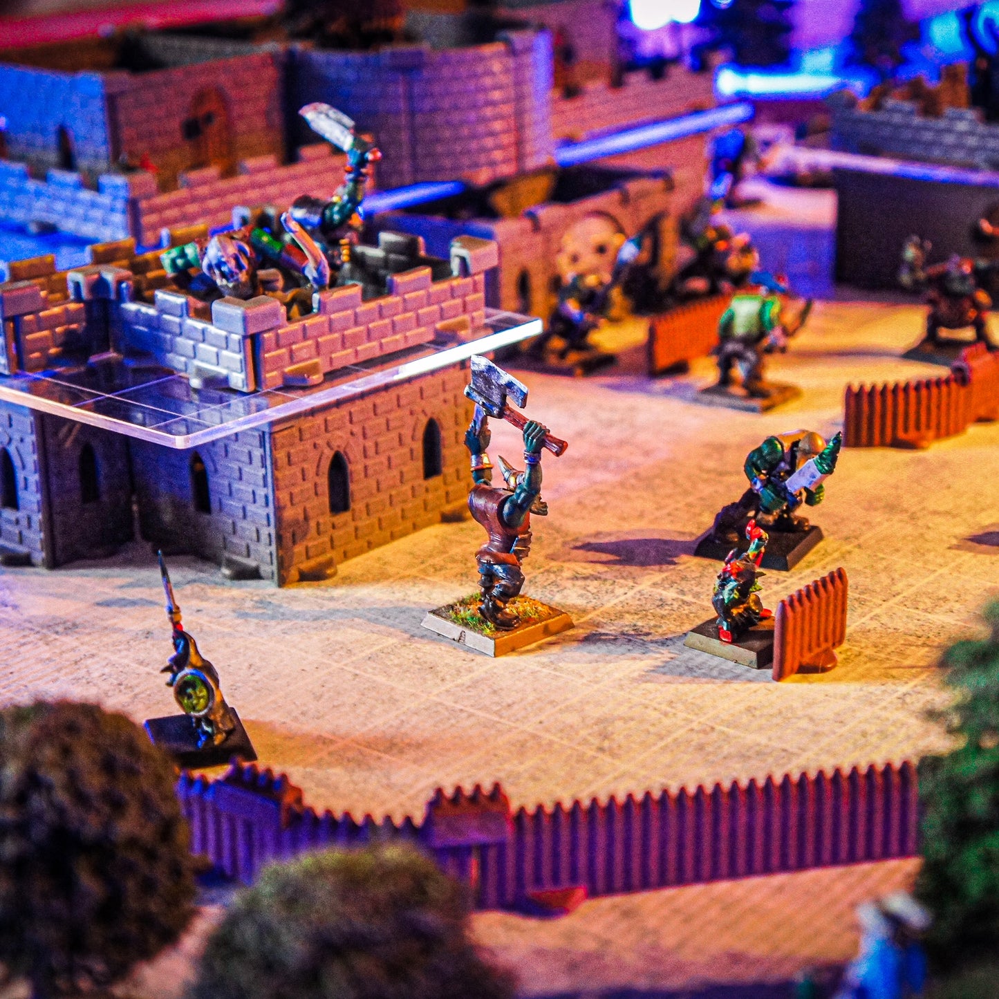 Close-up of a dramatic vertical combat scene in the Baron Castle Set. Miniatures are shown gathering on a second-story acrylic platform and a lower level, highlighting the multi-level D&D terrain.