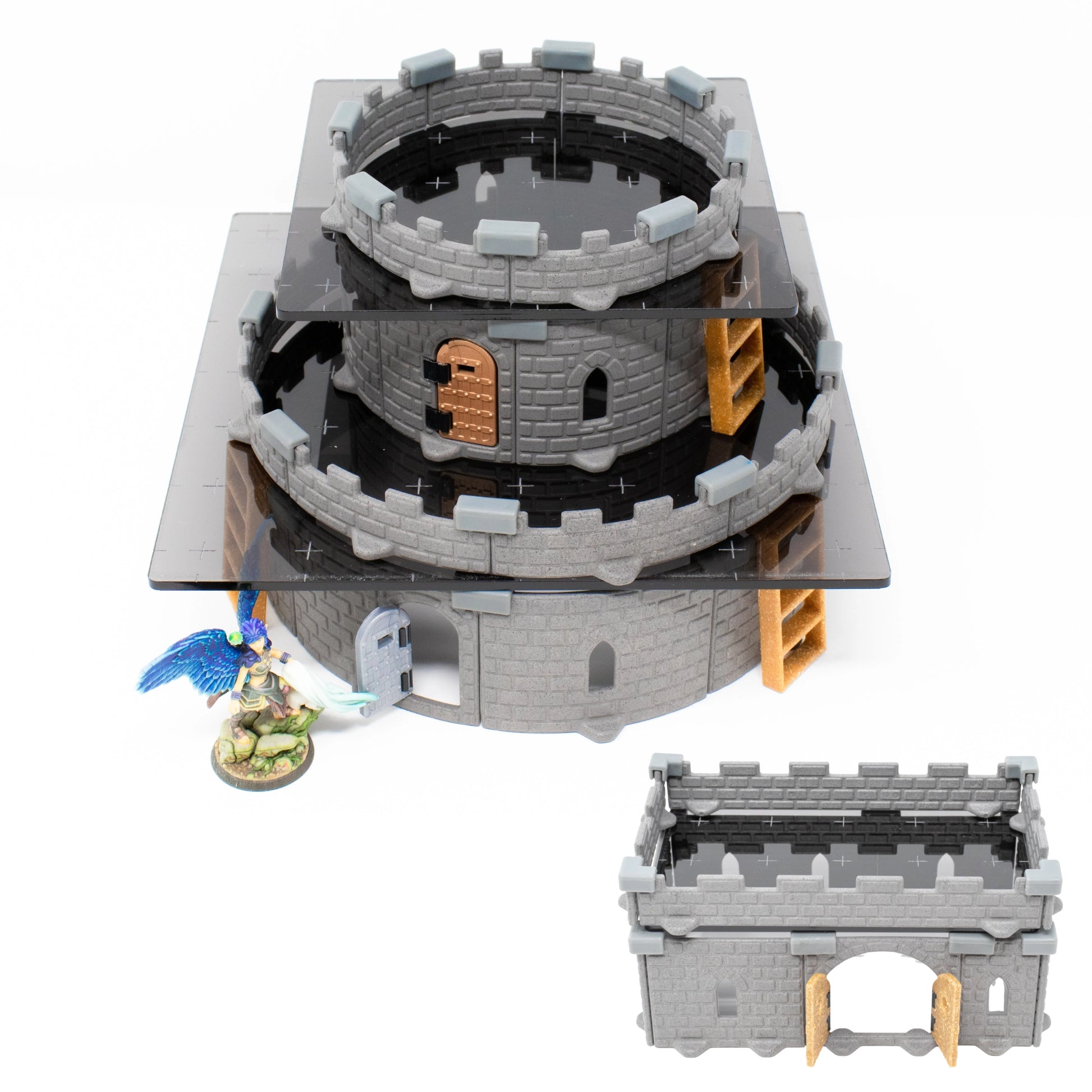 A hero miniature standing near a tower of dark gray acrylic platform accessed by modular ladders, demonstrating verticality in RPG terrain.