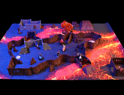 Wide view of the fully assembled modular layout of the Dragon's Lair Adventure Set, configured as a twisting cavern network with large rooms and a lava river running through the terrain.
