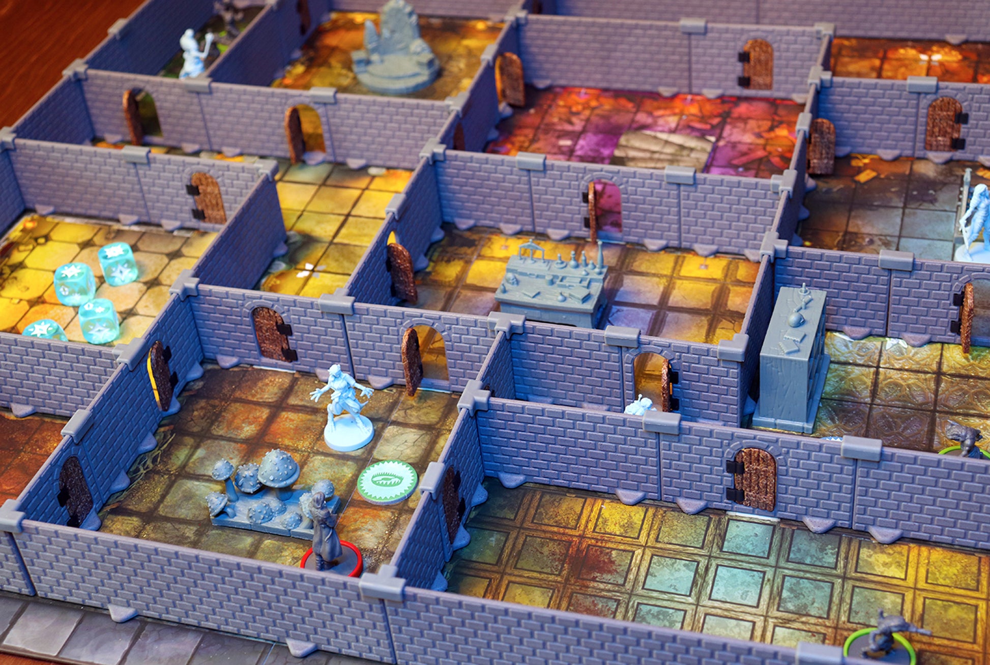 Close-up of a dungeon battle scene built with the AQ Set walls, featuring AltarQuest miniatures, terrain pieces, and colorful game board.