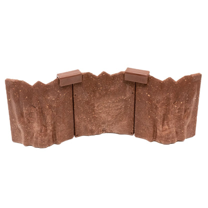 Isolated, detailed close-up of three connected Goblin Cavern modular wall pieces, clearly showing the brown, rugged rock texture and the dark clips used for assembly.