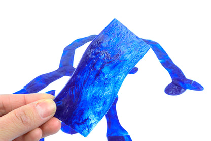 Close-up of a hand holding a single blue Waterway Section, showing the unique swirling water texture for a realistic 3D effect.