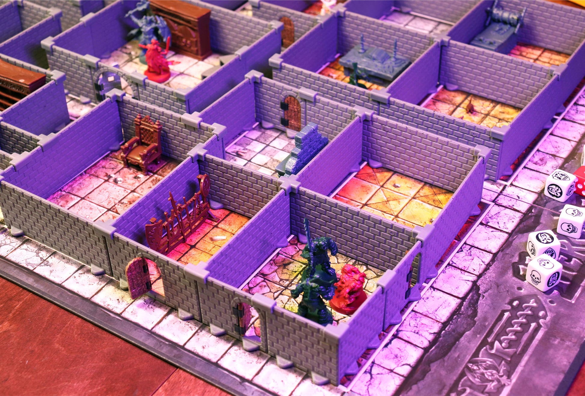 View of the HQ Set walls creating several dungeon rooms with various furniture pieces and HeroQuest miniatures under vibrant purple lighting.