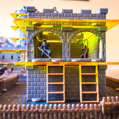 Close-up showing a large yellow acrylic platform creating a second floor in a dungeon, with hero miniatures taking the high ground.