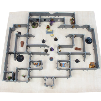 Bird's-eye view of the Rogue modular dungeon full set layout on a light-colored grid battle-map, featuring miniatures, chests, and terrain pieces arranged in a complex fantasy dungeon crawl scene.