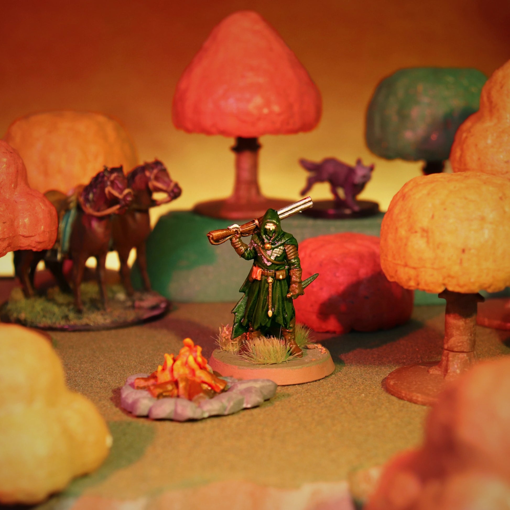 Tabletop RPG miniature standing next to a campfire accessory in a vibrant autumn forest scene with multi-colored trees.