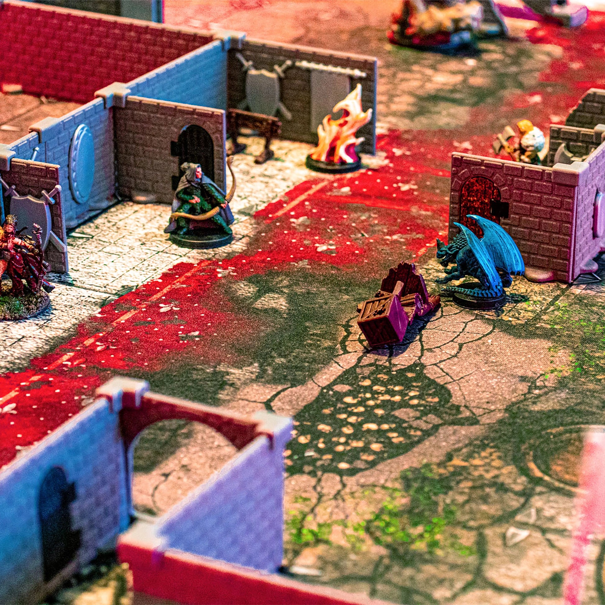 Detailed close-up shot of the Squire modular dungeon walls in an immersive tabletop RPG battle scene, featuring a red-and-white cracked battlemap, a dragon miniature, and other painted character miniatures.