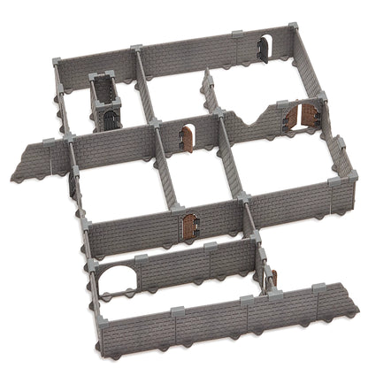 Isolated, clean image of the fully assembled grey modular dungeon terrain set with connecting walls and various doorways, showing the grid-based design and injection-molded brick texture.
