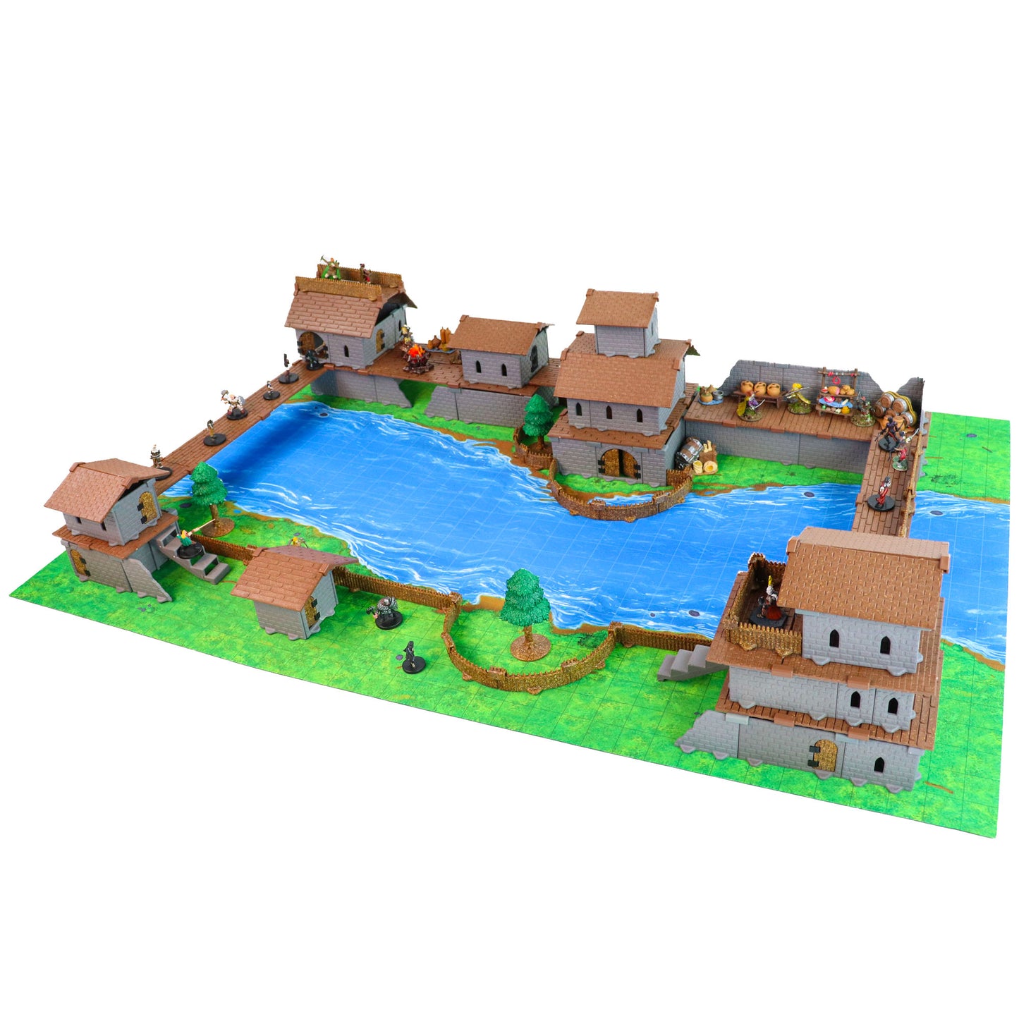 Village terrain scene featuring buildings on a river map mat, showcasing the Village Roof Kit on multi-story structures next to water.