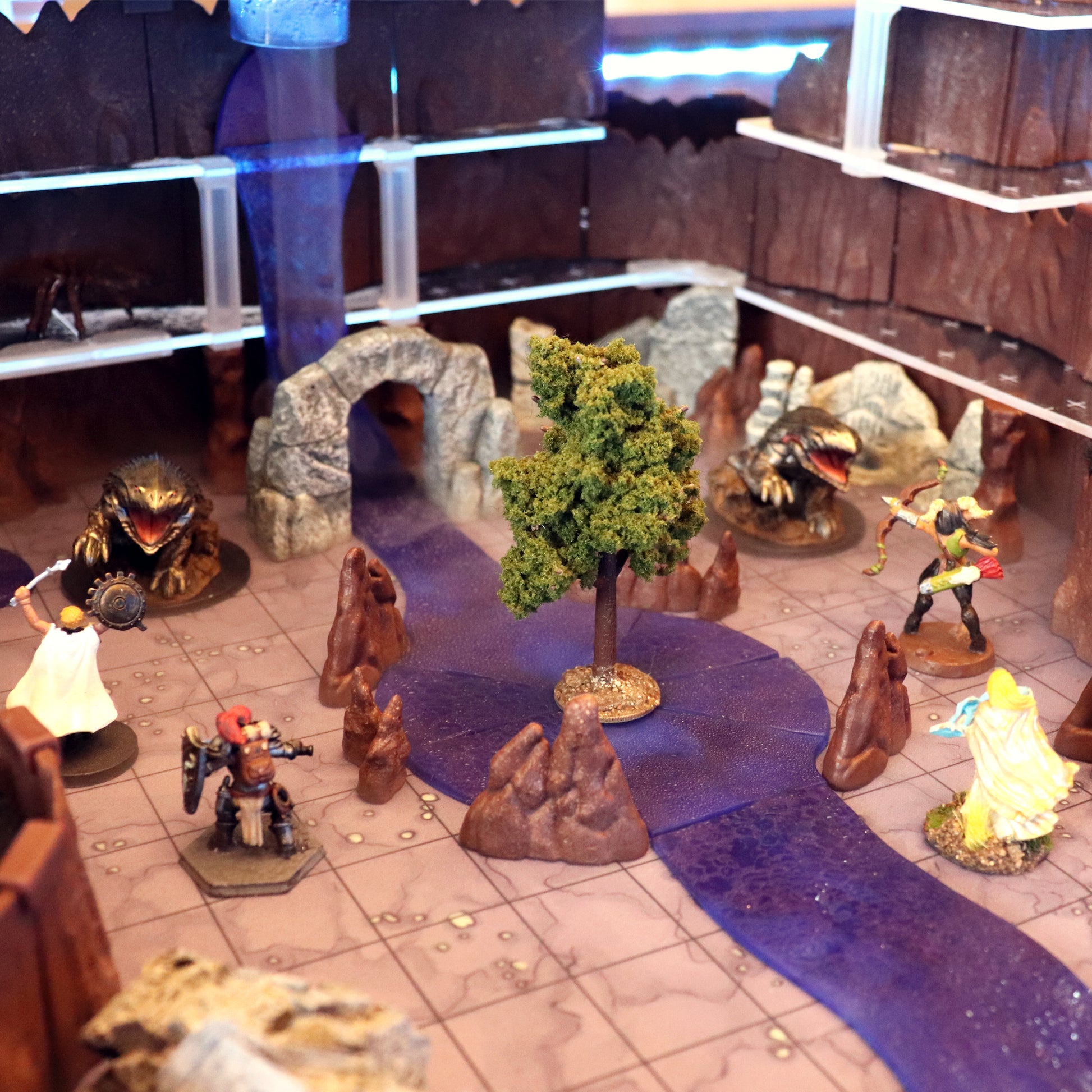 A large, winding river and waterfall created using the Waterways Kit modular sections, featuring 3D water effects and an island terrain piece for tabletop RPGs.