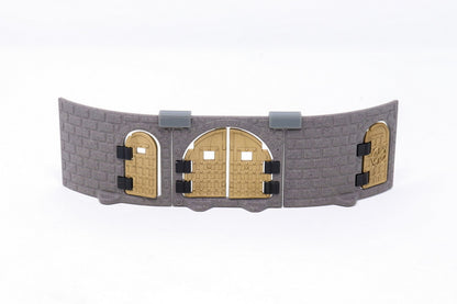 Gray modular castle wall section featuring three installed gold/bronze metallic doors of different shapes and designs.